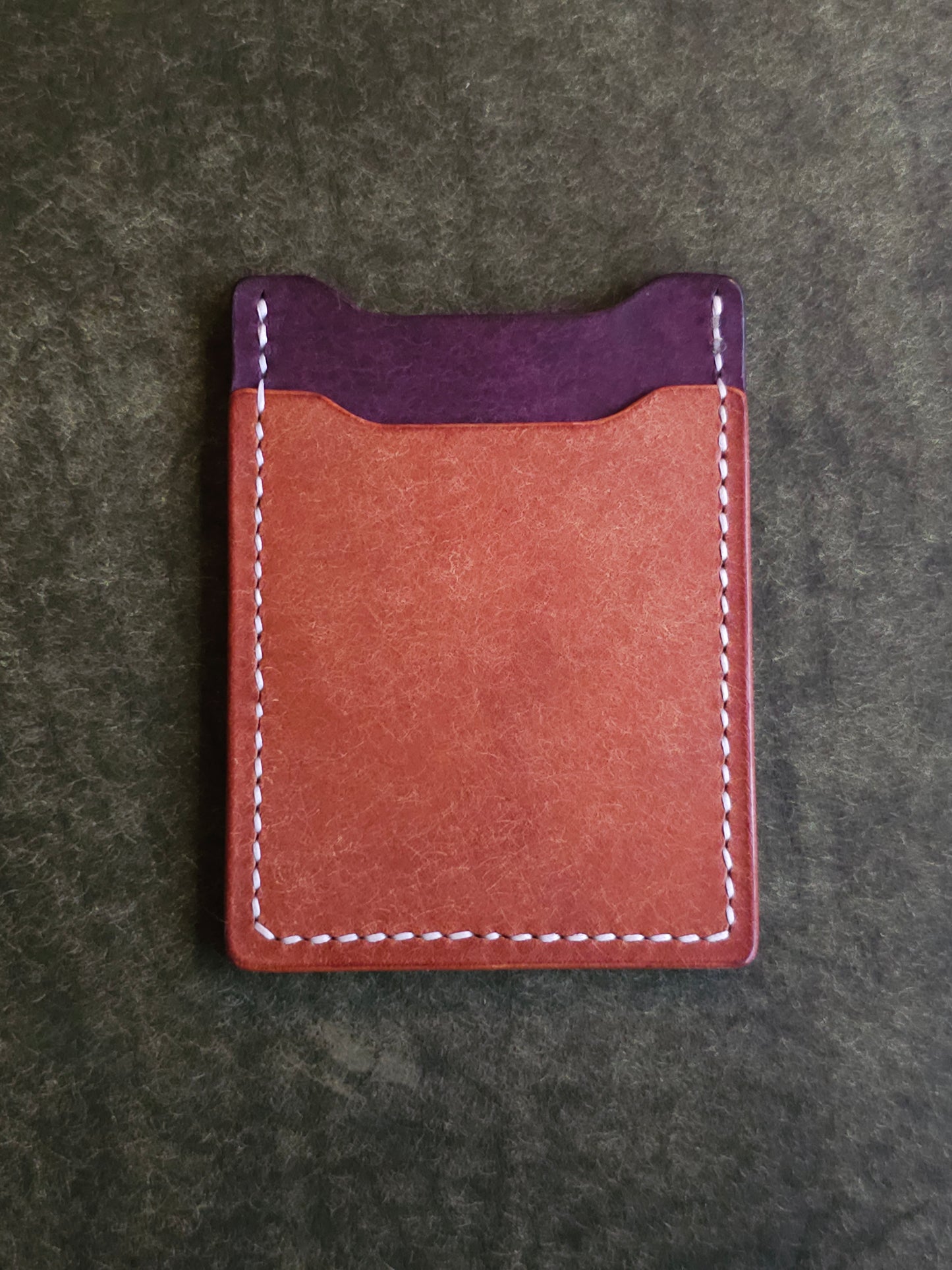 Back of leather card holder with angled pocket.