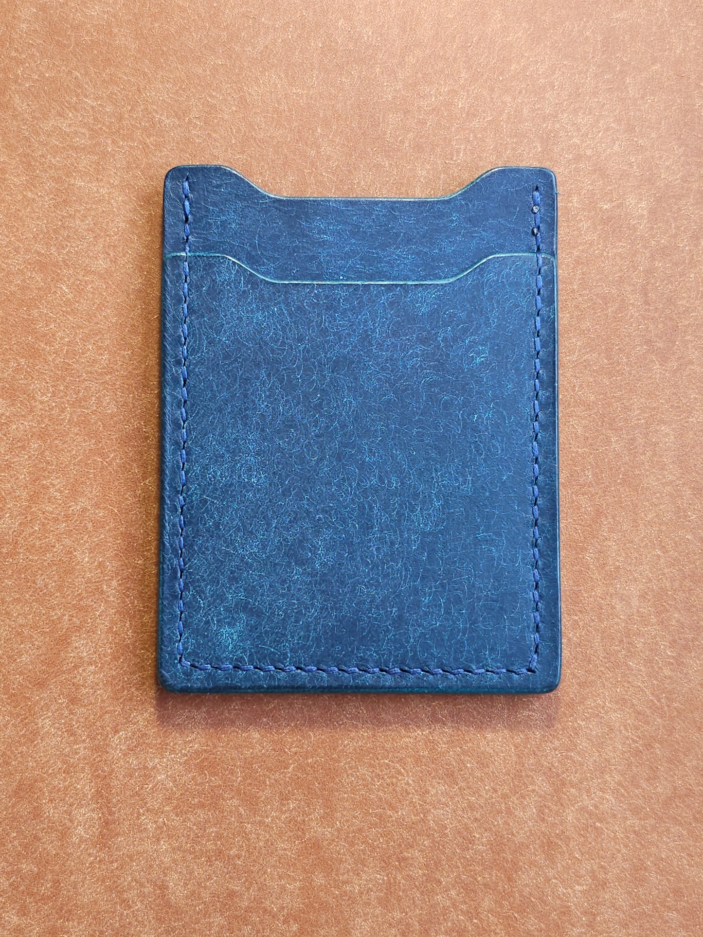 Back of leather card holder with angled pocket.