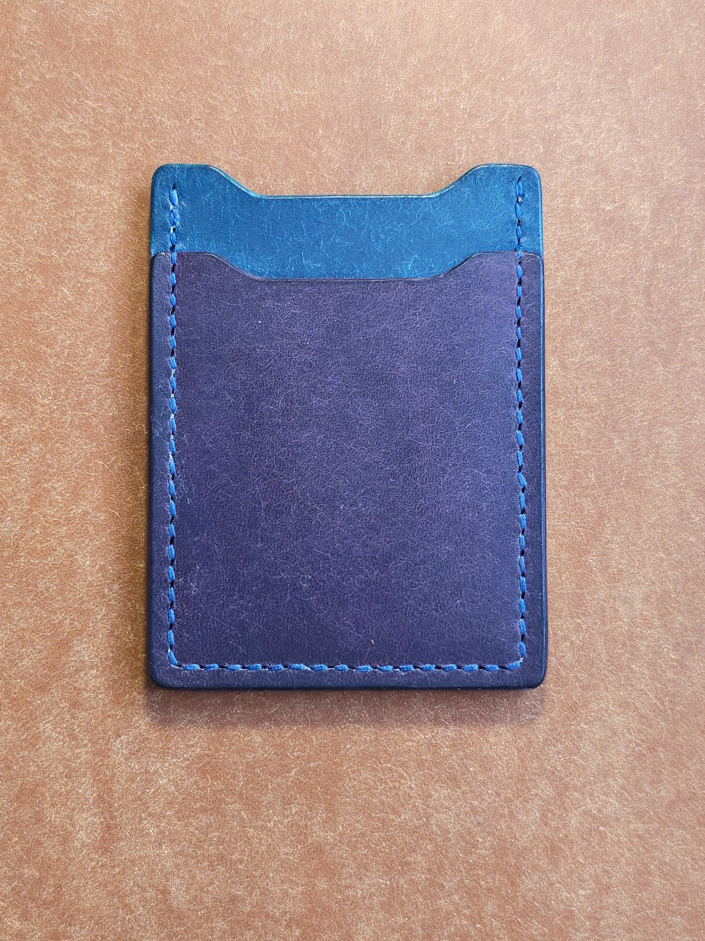 Back of leather card holder with angled pocket.