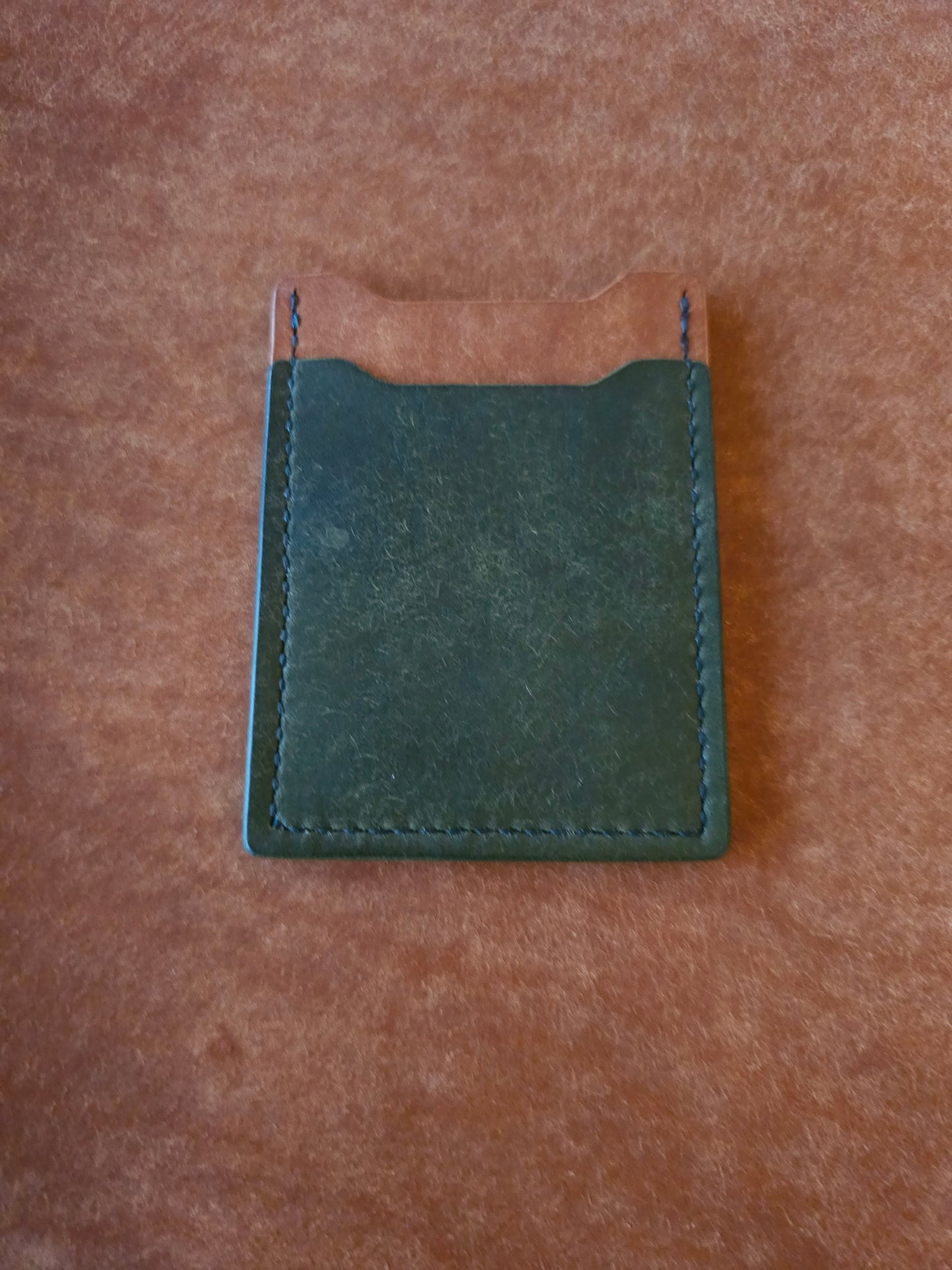 Back of leather card holder with angled pocket.