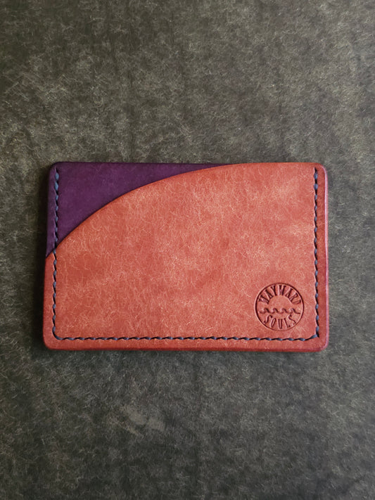 Leather card holder with pocket shaped like a sunset. Wayward Souls logo is stamped in the bottom right corner of the wallet.