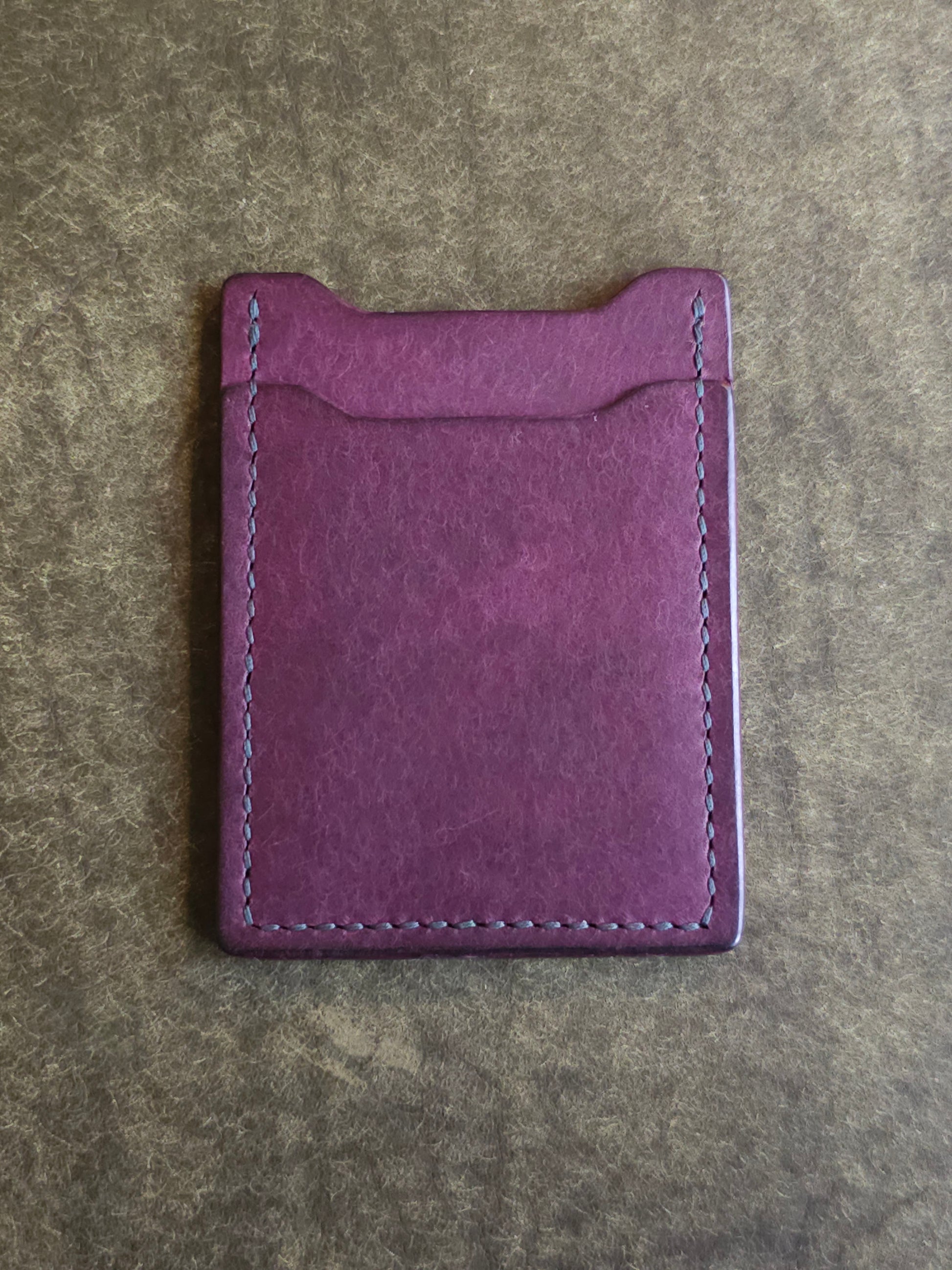 Back of leather card holder with angled pocket.