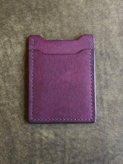 Back of leather card holder with angled pocket.