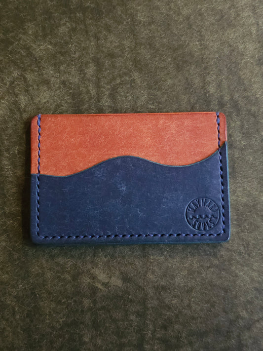 Back of leather card holder with pocket shaped like a wave.