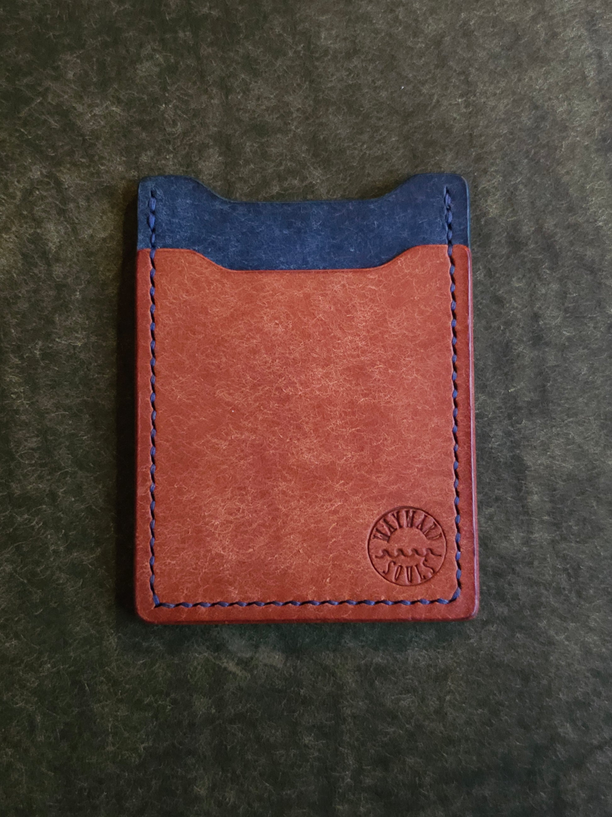 Leather card holder with angled pocket. Wayward Souls logo is stamped in the bottom right corner of the wallet.