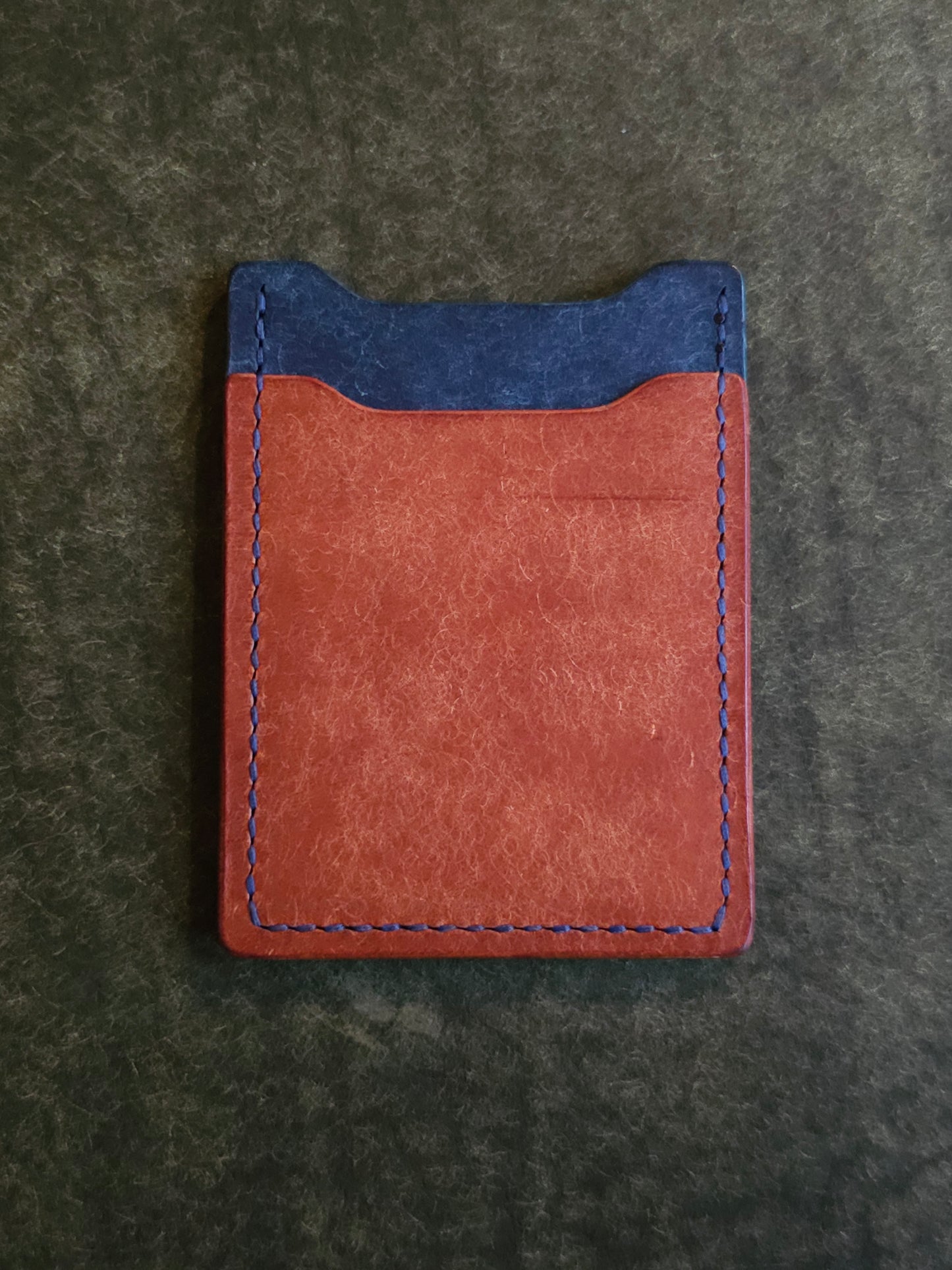 Back of leather card holder with angled pocket.