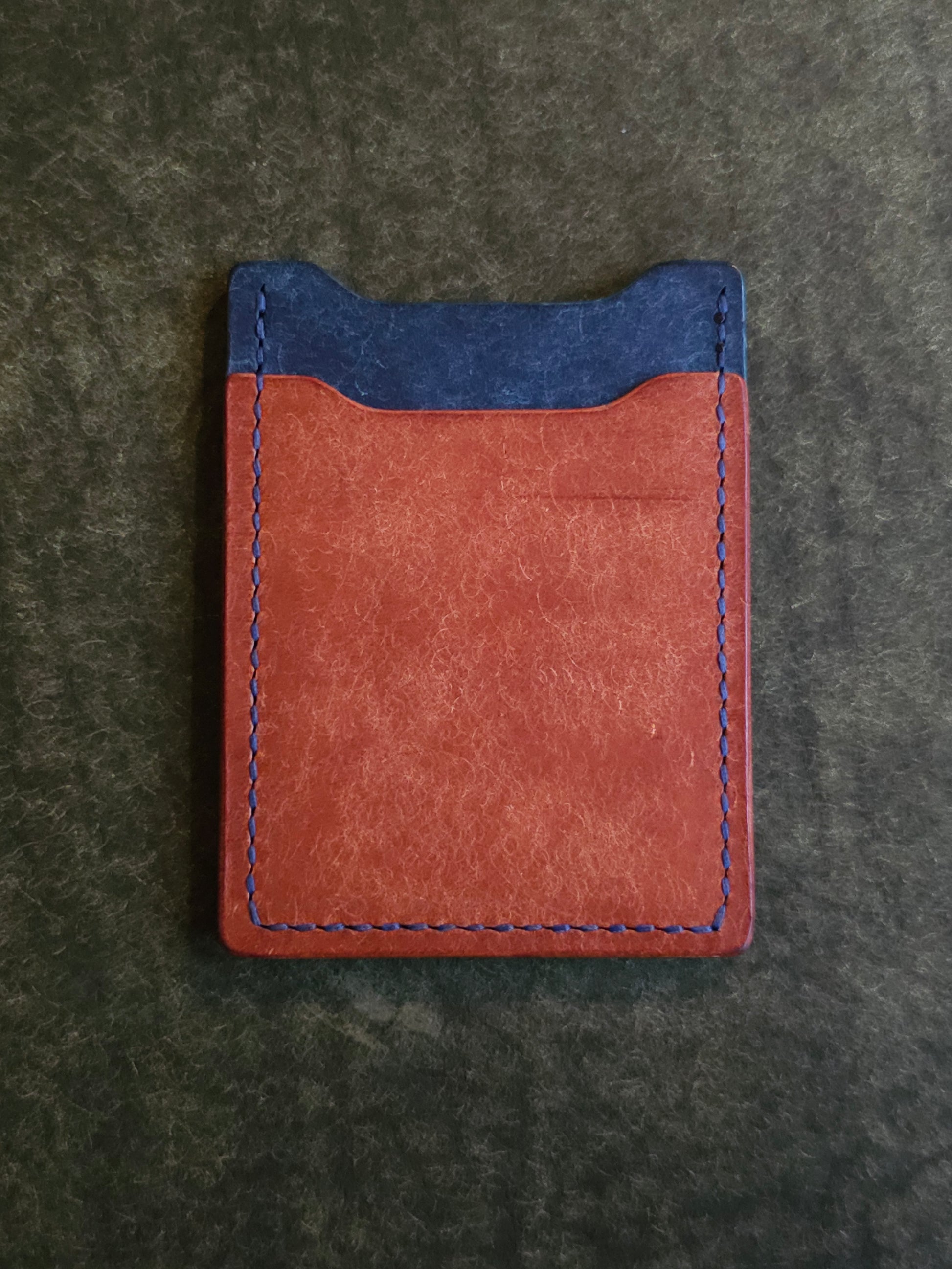 Back of leather card holder with angled pocket.