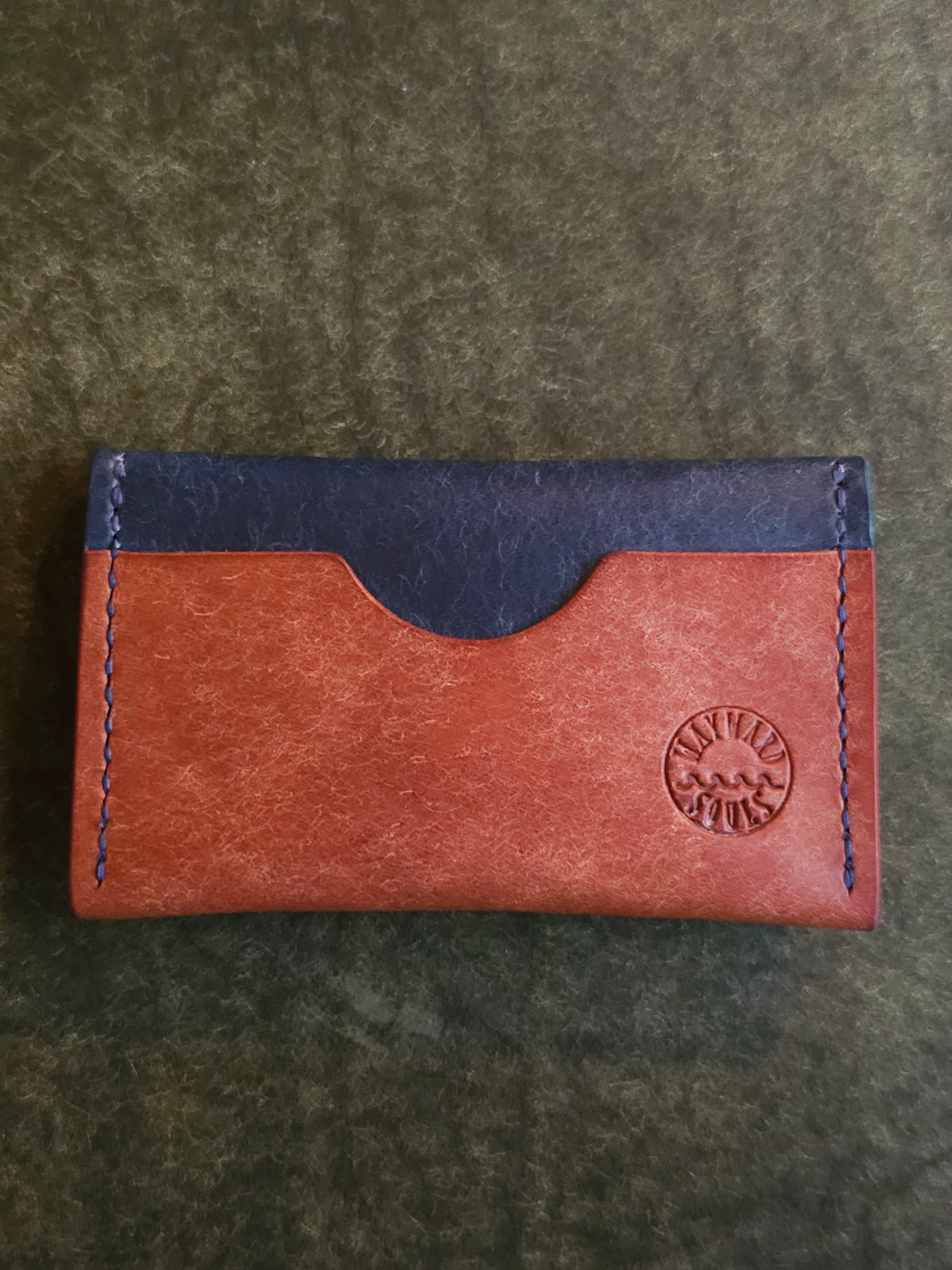 Back of card holder with a single pocket. The Wayward Souls logo in stamped in the bottom right corner.