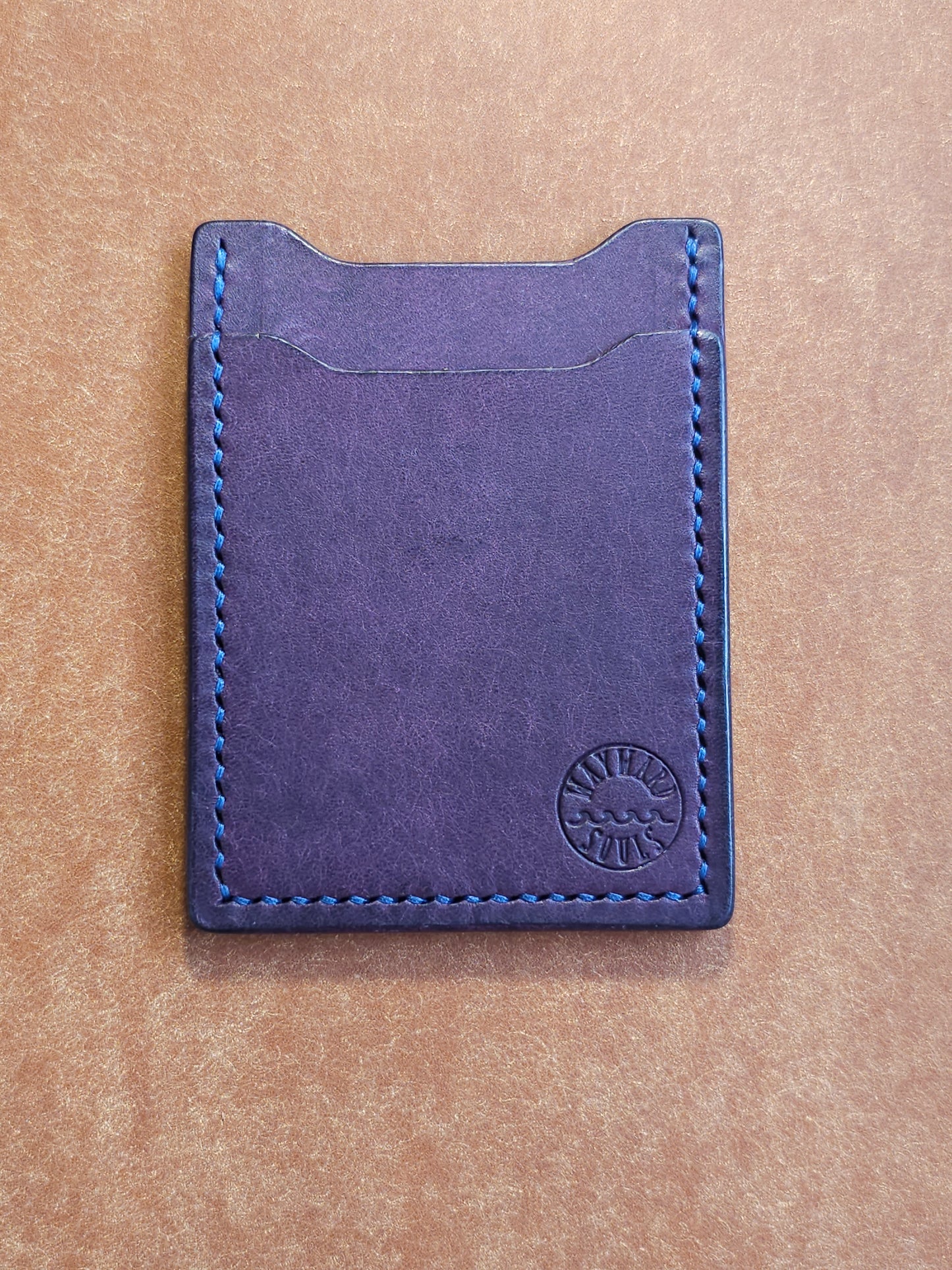 Leather card holder with angled pocket. Wayward Souls logo is stamped in the bottom right corner of the wallet.