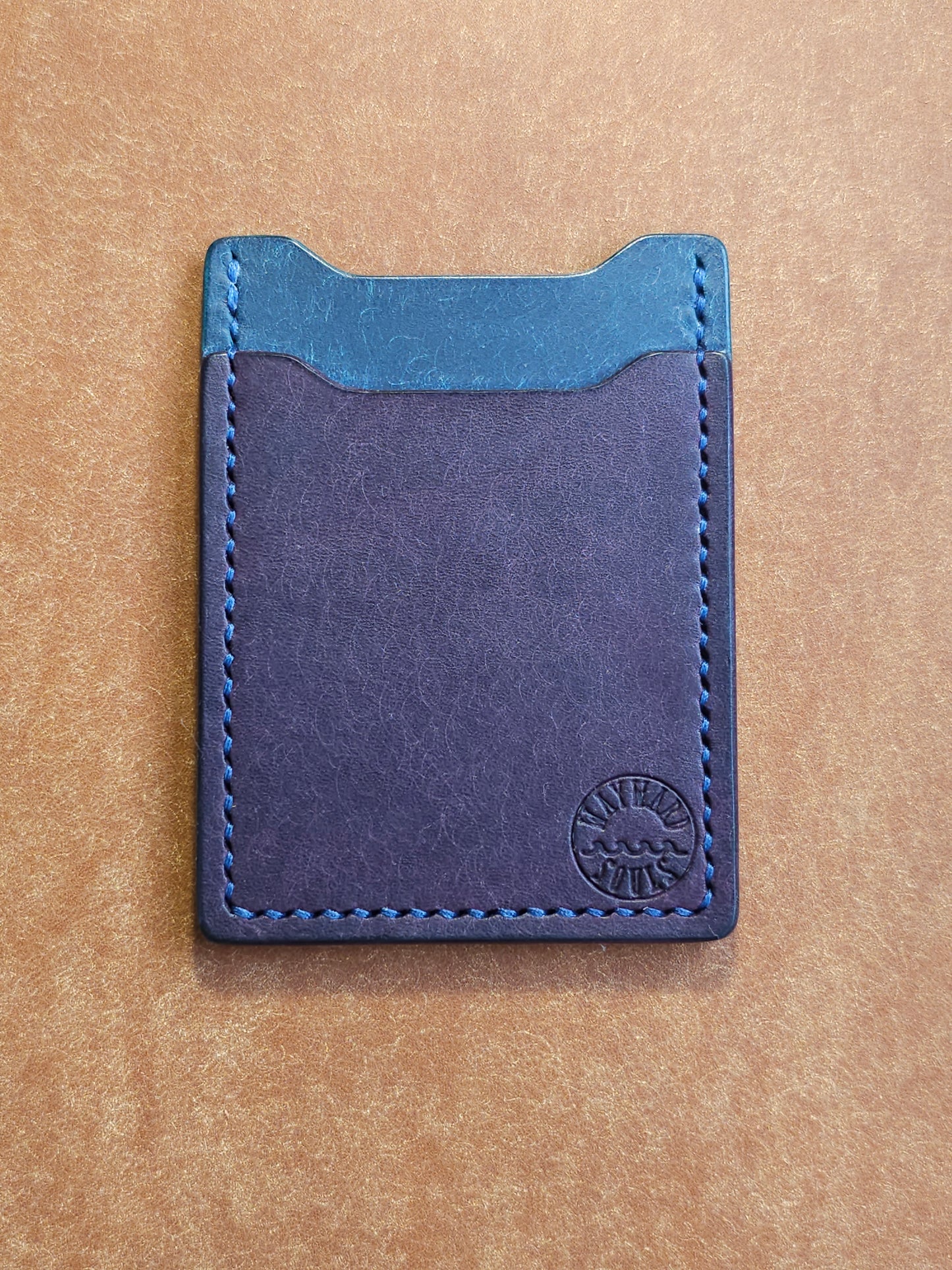Leather card holder with angled pocket. Wayward Souls logo is stamped in the bottom right corner of the wallet.