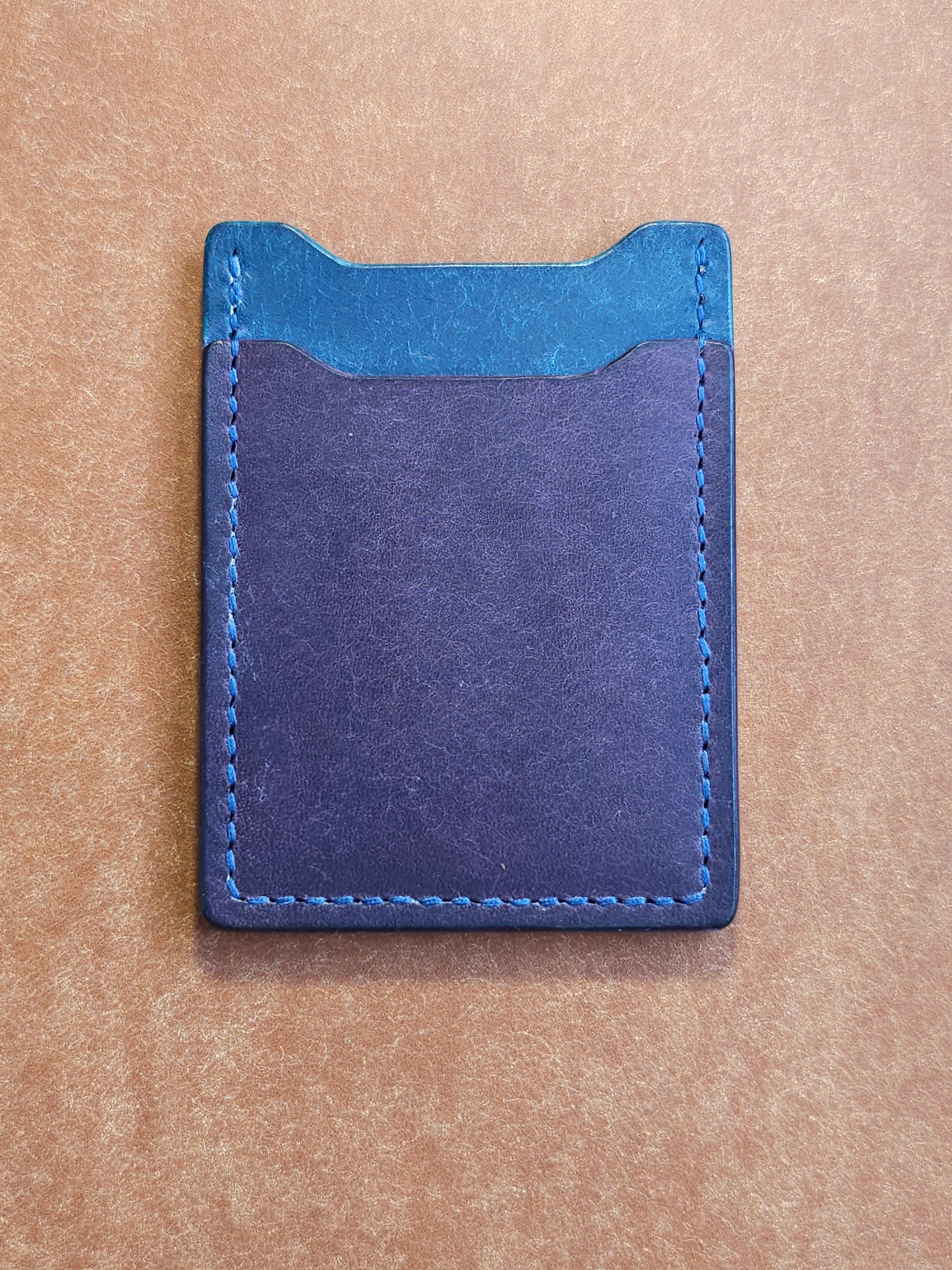 Back of leather card holder with angled pocket.