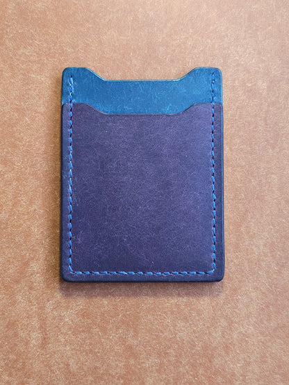 Back of leather card holder with angled pocket.