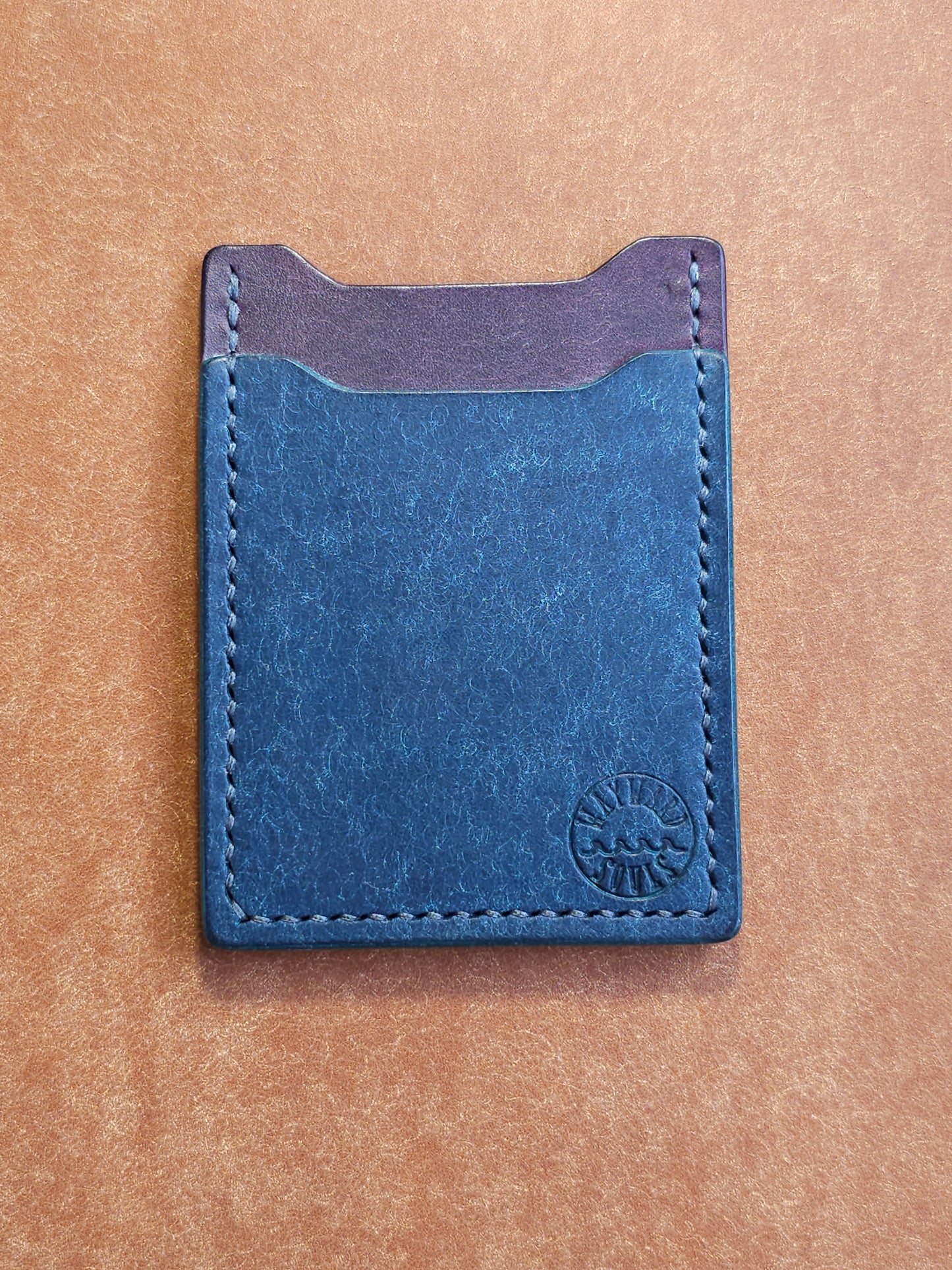 Leather card holder with angled pocket. Wayward Souls logo is stamped in the bottom right corner of the wallet.