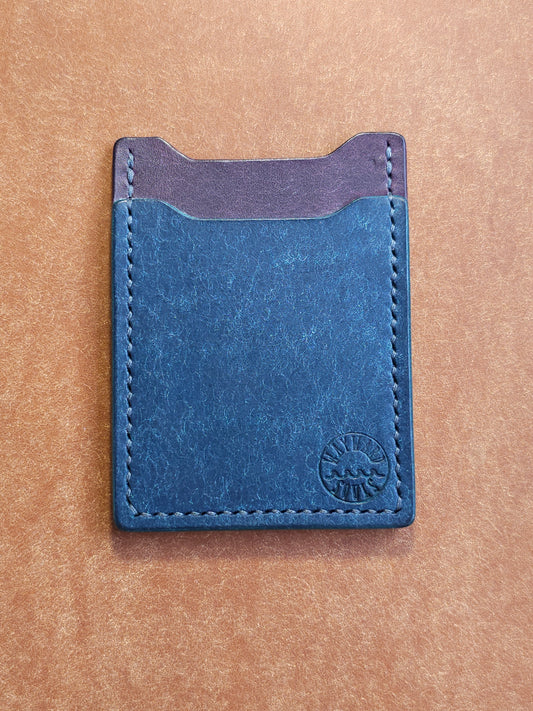 Leather card holder with angled pocket. Wayward Souls logo is stamped in the bottom right corner of the wallet.