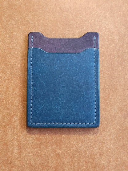 Back of leather card holder with angled pocket.
