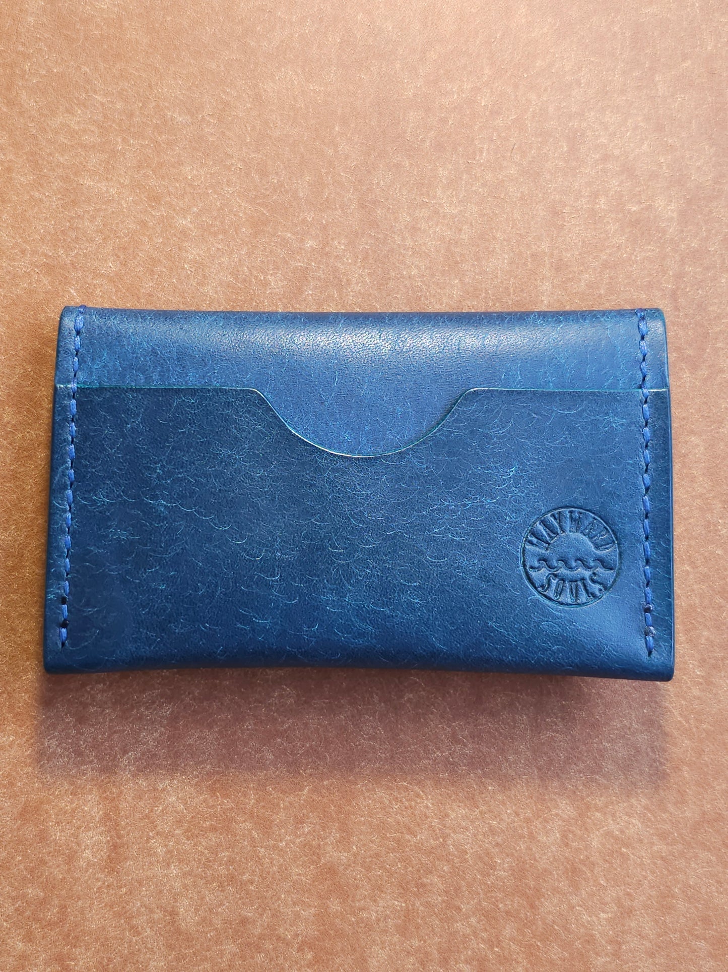 Back of card holder with a single pocket. The Wayward Souls logo in stamped in the bottom right corner.